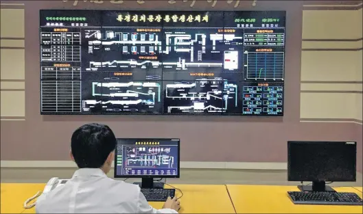  ?? AP PHOTO ?? An employee monitors production from the control room of the Ryugyong Kimchi Factory in Pyongyang, North Korea.