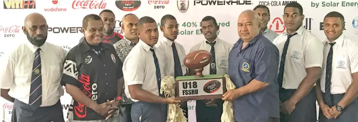  ?? Photo: Vilimoni Vaganalau ?? Fijian Secondary Schools Rugby Union committee members, sponsors and representa­tives from Ratu Kadavulevu School and Queen Victoria School with the Coke Zero Deans U-18 trophy during the press conference in Suva on August 10, 2017.