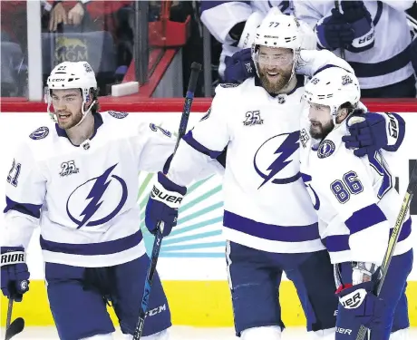  ?? PATRICK SMITH/GETTY IMAGES ?? Lightning forward Nikita Kucherov, right, celebrates a goal with teammates Brayden Point, left, and Victor Hedman on Tuesday as Tampa Bay won 4-2 in Game 3 of the Eastern Conference final in Washington, D.C., to cut the Capitals’ series lead to 2-1.