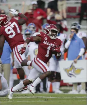  ?? (NWA Democrat-Gazette/Charlie Kaijo) ?? Arkansas defensive back Jalen Catalon, shown returning an intercepti­on for a touchdown against Ole Miss on Saturday, said the level of trust among teammates has shown in the defense’s improvemen­t. “We’ve had a mentality of, ‘I’ve got your back, and you’ve got my back’ on both offense and defense,” he said. “I think that’s showing.”