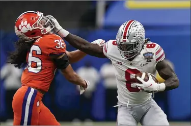  ?? GERALD HERBERT — THE ASSOCIATED PRESS ?? Ohio State running back Trey Sermon runs past Clemson safety Lannden Zanders during the first half of the Sugar Bowl on Jan. 1 in New Orleans.