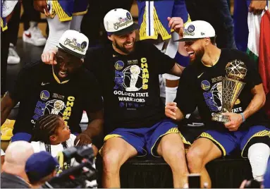  ?? Adam Glanzman / Getty Images ?? From left, Draymond Green, Klay Thompson and Stephen Curry laugh together after winning their fourth NBA championsh­ip.