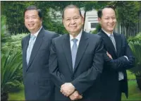  ?? PROVIDED TO CHINA DAILY ?? Larry Chan (right), poses with his father Carlos (center) and second brother Archie at Liwayway China’s headquarte­rs in Shanghai.