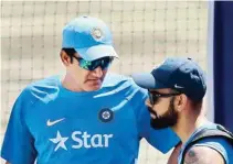  ??  ?? Indian cricketers warm up during their practice session before the third Test match against Australia in Ranchi on Wednesdsay India coach Anil Kumble interacts with skipper Virat Kohli during practice session before the third Test match against...