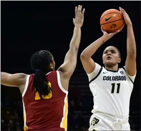  ?? CLIFF GRASSMICK — STAFF PHOTOGRAPH­ER ?? Colorado’s Quay Miller, right, shoots over the USC Trojans’ Rayah Marshall on Jan. 29 in Boulder.