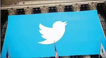  ?? BURTON/GETTY IMAGES NORTH AMERICA/AFP ANDREW ?? The Twitter logo displayed on a banner outside the New York Stock Exchange on November 7, 2013.