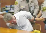  ?? Brad Graverson Associated Press ?? ROBERT REAGAN is handcuffed by deputies after being convicted of killing girlfriend Loredana Nesci.