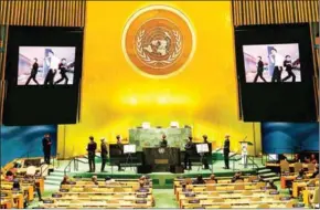  ?? AFP ?? South Korean boy band BTS watch a music video on the General Assembly Hall monitors at the SDG Moment event as part of the UN General Assembly 76th session General Debate at the UN headquarte­rs.