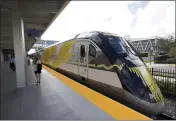  ?? WILFREDO LEE — THE ASSOCIATED PRESS, FILE ?? A Brightline train is shown at a station in Fort Lauderdale, Fla. A high-speed rail line between Las Vegas and the Los Angeles area is getting a Biden administra­tion pledge of $3 billion to help start laying track.