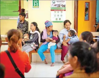 ?? AHC ?? Mothers bring their children for treatment at Angkor Hospital for Children in Siem Reap in 2021.
