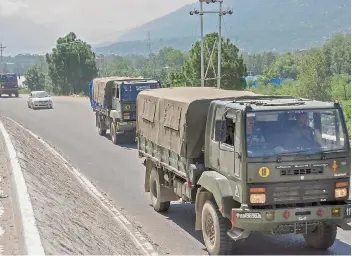  ?? —PTI ?? Army trucks move along the Manali-Leh highway in Kullu district on Wednesday amid border tension between India and China.