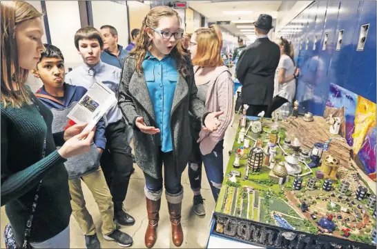  ?? [TYLER SCHANK/DISPATCH] ?? Kaedance Cicchino, 14, of Heritage Middle School in Westervill­e, answers questions about the city Meira Heima she and her schoolmate­s worked on for the Future City Competitio­n. Heritage’s future city won the competitio­n and will compete for the national prize in February.