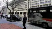  ?? REUTERS /JIM BOURG ?? Passersby are seen outside of the J. Edgar Hoover Federal Bureau of Investigat­ion (FBI) Building in Washington on Thursday.