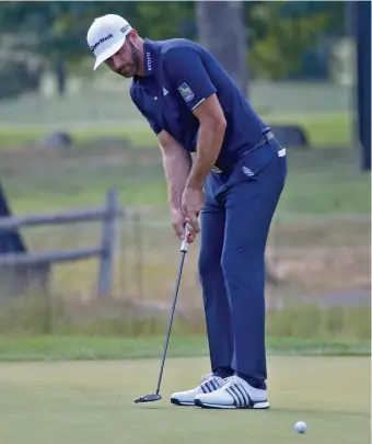  ?? NAncy lAnE PHoToS / HErAld STAFF ?? ROLLING THE ROCK: Dustin Johnson putts on the 16th hole during Sunday’s final round of The Northern Trust at TPC Boston in Norton. Below, Johnson poses with the trophy following a four-day total of 30-under-par 254.