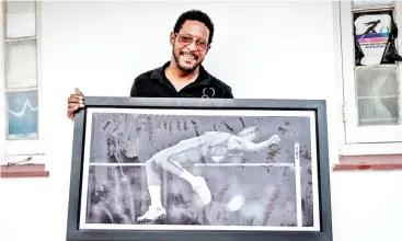  ?? — AFP photos ?? Sotomayor poses with a picture of himself during an interview with AFP in Havana, Cuba.