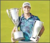  ?? Associated Press ?? Viktor Hovland holds the Western Golf Associatio­n Trophy (left) and the BMW Championsh­ip Trophy after winning in the final round of the BMW Championsh­ip on Sunday in Olympia Fields, Ill.
