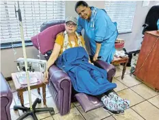  ?? LEN’S NEWS Picture: ?? HAPPY FEET: Charnae Schmidt, who used to live in Komani, received ‘bedsox’ from Camilla Kameel, the supervisor of chemothera­py at the East London Oncology Centre