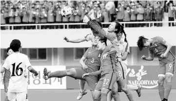  ?? — Reuters photo ?? South Korea goalkeeper Kim Jung-mi punches the ball during their AFC Women’s 2018 Asian Cup Group B qualifying match against North Korea at the Kim Il-Sung stadium in Pyongyang.