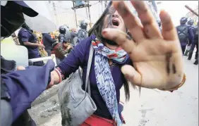  ?? Reuters ?? A policeman helps an RPP activist to stand up after the baton charge.