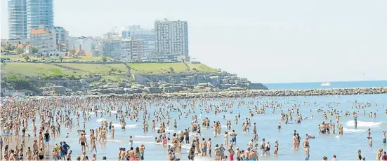  ?? FABIÁN GASTIARENA ?? Todos al agua. Ayer, en Mar del Plata, el termómetro llegó a 31,8° y el mar se llenó. La ocupación en los hoteles ronda el 80%.