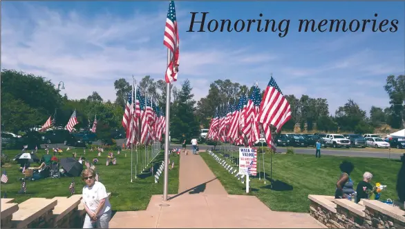  ?? JOHN BAYS/NEWS-SENTINEL ?? American flags line a walkway at Cherokee Memorial Park on Memorial Day.