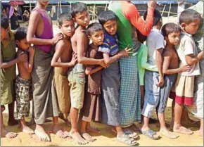  ?? DOMINIQUE FAGET/AFP ?? Rohingya children line up for relief supplies at a refugee camp for Rohingyas who have fled to Bangladesh to escape violence in Myanmar on Friday.