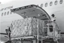  ?? Anna Moneymaker/Getty Images ?? Pallets of baby formula are removed from a United Airlines passenger plane arriving from London Heathrow Airport at the Dulles Internatio­nal Airport last week in Virginia.