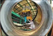  ?? YANG SHIYAO / XINHUA ?? A technician works on a key component of the Hualong One reactor in Qinhuangda­o, Hebei province.