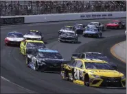  ?? CHARLES KRUPA — THE ASSOCIATED PRESS ?? Erik Jones (20) banks into the first turn during a NASCAR Cup Series race at New Hampshire Motor Speedway in Loudon, N.H. on July 21.