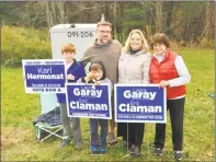  ?? Ben Lambert / Hearst Connecticu­t Media ?? New Hartford Selectman Laura Garay and school board candidate Karl Hermon, accompanie­d by family members, show their campaign signs on Election Day.