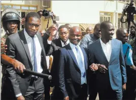  ?? THE ASSOCIATED PRESS ?? Kenya doctors union Secretary General Dr. Ouma Oluga, left, Chairman Dr. Samuel Oroko, center, and Vice-Chairman Dr. Allan Ochanji, right, are taken away to a police vehicle Monday after a court hearing in Nairobi, Kenya. A Kenyan judge has jailed...