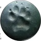  ??  ?? Some local veterinary clinics will create permanent paw prints, like this one, for owners to keep after their pets have passed away.