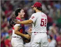  ?? MATT SLOCUM — THE ASSOCIATED PRESS ?? Phillies pitcher Brad Hand, right, and catcher Garrett Stubbs celebrate after the final out on Friday night.