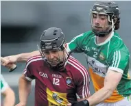  ??  ?? TUG-OF-WAR Westmeath’s Robbie Greville is tackled by Ben Conneely of Offaly in the Faithful’s victory last night