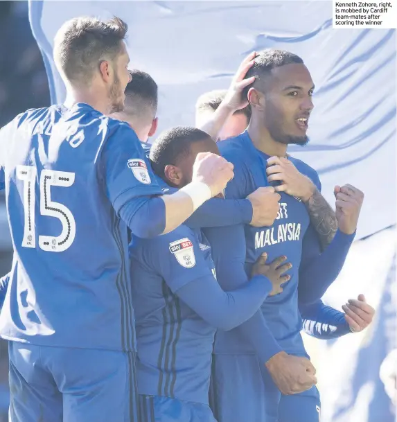  ??  ?? Kenneth Zohore, right, is mobbed by Cardiff team-mates after scoring the winner