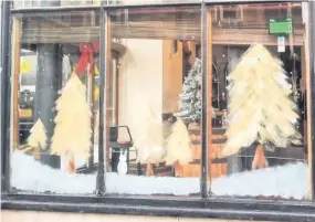  ??  ?? ●● Dawn Hamer, inset left, has been painting festive windows around Rossendale