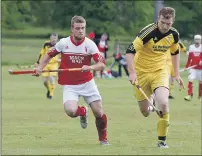  ?? Photograph: Stephen Lawson. ?? Inveraray’s Lewis MacNicol and Bute’s Colin Lawrence in a chase for the ball during the Balliemore Cup match at the Winterton.