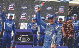  ?? AARON E. MARTINEZ/AMERICAN-STATESMAN/USA TODAY NETWORK ?? Kyle Larson celebrates winning the NASCAR Xfinity Series race in Texas on March 23. Larson also won last year’s Cup Series race at Richmond, the site of NASCAR racing this weekend.