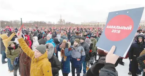  ?? — AFP ?? Supporters of Alexey Navalny hold ballots as a symbol to nominate him as opposition candidate for the upcoming presidenti­al election in Moscow on Sunday.