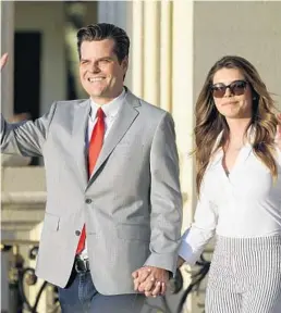  ?? MARTA LAVANDIER/AP ?? U.S. Rep. Matt Gaetz, R-Fort Walton Beach, and his girlfriend, Ginger Luckey, enter the “Women for American First” event April 9 in Doral. Gaetz eloped to Southern California, marrying Luckey in a small ceremony on Catalina Island.