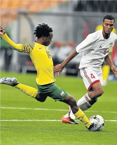  ?? Picture: LEFTY SHIVAMBU/GALLO IMAGES ?? STYLISH STRIKER: Percy Tau, of Bafana Bafana, and Nigel Nigel, of Seychelles, during their 2019 Africa Cup of Nations qualificat­ion match at the FNB Stadium in Johannesbu­rg