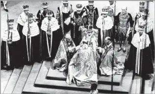  ?? Associated Press ?? THE NEW QUEEN
Elizabeth receives the fealty of the bishop of Durham, center left, the archbishop of Canterbury and the bishop of Bath and Wells during her coronation in Westminste­r Abbey on June 2, 1953.