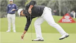  ??  ?? SHANGHAI: Japan’s Hideki Matsuyama recovers the ball after finishing at 18th hole during the 2016 WGC-HSBC Champions golf tournament at the Sheshan Internatio­nal Golf Club in Shanghai, China, yesterday. — AP