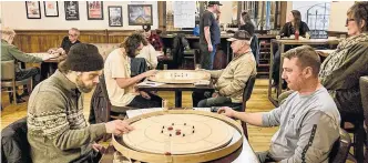  ?? CONTRIBUTE­D ?? People were focused on the game of crokinole while at the Church Brewing Company in Wolfville recently. It’s been said that crokinole has an enthusiast­ic following in Nova Scotia.