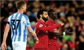  ??  ?? Mohamed Salah and Sadio Mané celebrate after the Senegalese forward scored Liverpool’s second goal. Photograph: Michael Regan/Getty Images