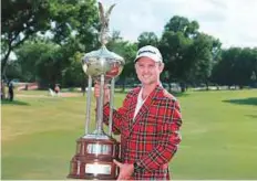  ?? AFP ?? Justin Rose of England with the trophy after winning the Fort Worth Invitation­al in Texas on Sunday.