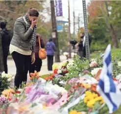  ??  ?? A makeshift memorial welcomes mourners outside the Tree of Life Congregati­on Synagogue in Pittsburgh.