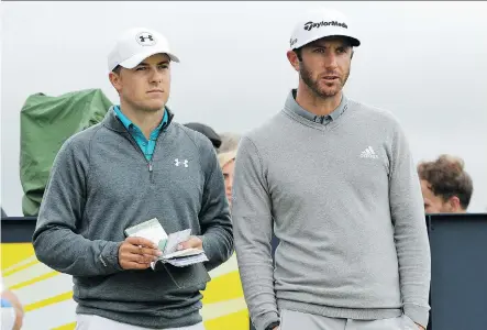  ?? DAVID J. PHILLIP/ THE ASSOCIATED PRESS ?? Americans Jordan Spieth, left, and Dustin Johnson chat during first- round action at the British Open on Thursday. Johnson shot a 65, the best score of the day, while Spieth was just two strokes back after the first 18 holes at St. Andrews.