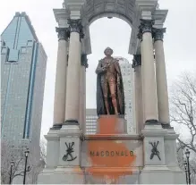  ?? RYAN REMIORZ, THE CANADIAN PRESS ?? Vandals spay-painted this statue of Canada’s first prime minister in downtown Montreal early Thursday.