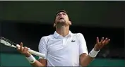  ?? ALASTAIR GRANT / AP ?? Serbia’s Novak Djokovic reacts as he plays Italy’s Jannik Sinner in a men’s singles quarterfin­al match on day nine of the Wimbledon tennis championsh­ips in London on Tuesday.
